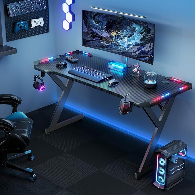 HLDIRECT 55 Inch Gaming Desk with LED Lights Ergonomic Computer Gaming Table with Carbon Fibre Surface Sturdy PC Workstation Desk for Home Office with Headphone Hook Cup Holder Black