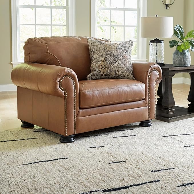 Signature Design by Ashley Carianna Contemporary Leather Match Upholstered Oversized Chair with Nailhead Trim and 1 Accent Pillow Dark Brown